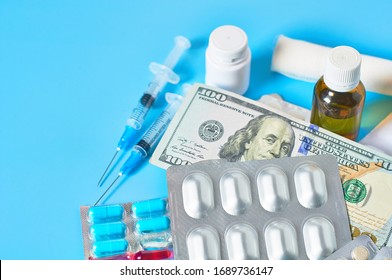 Different Medicaments And Money On Blue Background. Medical Concept. Doctor Salary. Corruption In Healthcare.  Purchase Of Drugs. Health Insurance. Virus Vaccine Manufacturing Cost