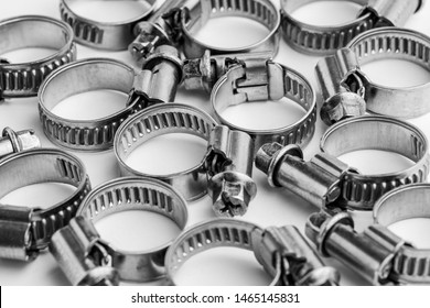 Different metal clamps for hose connection isolated on white background close up.