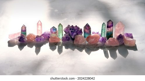Different Minerals on marble background. Healing stones for Crystal Ritual, modern magic. esoteric spiritual practice, aura cleansing, relax. reiki therapy. Set of Fluorite, amethyst, rose quartz