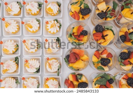 A lot of different mini appetizers on the table for a Banquet. Gourmet snacks for party, food catering service. Exotic snack dishes with natural ingredients. Beautifully decorated catering banquet 