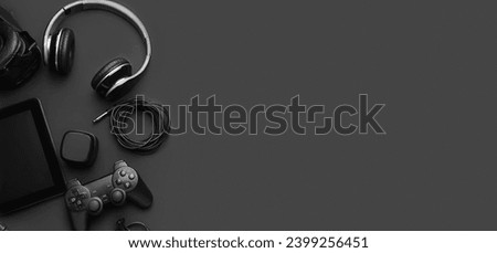 Different modern devices and gadgets on black background with space for text