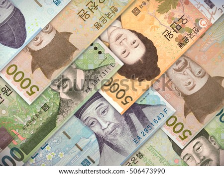 Different money bills stacked over each other forming a money background. 
