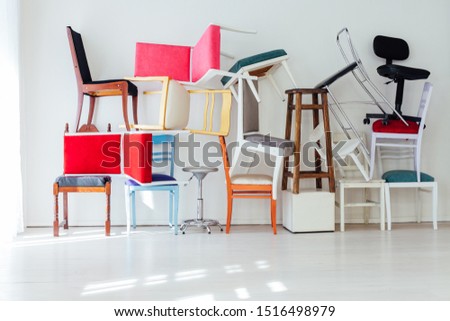 different multicolored chairs in the interior of the white room