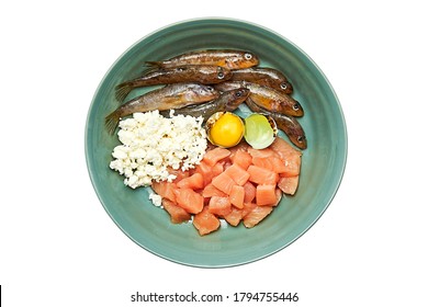 Different Natural Raw Cat Pet Food Ingredients In Bowl Isolated On White Background Meat Fish Eggs And Dairy Products.