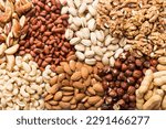 different nuts background. Close up, top view, flat lay. Walnut, pistachios, almonds, hazelnuts and cashews