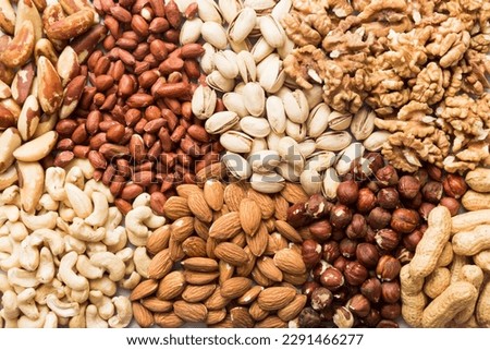 different nuts background. Close up, top view, flat lay. Walnut, pistachios, almonds, hazelnuts and cashews
