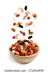 Different Nuts Falling Into Bowl On White Background 