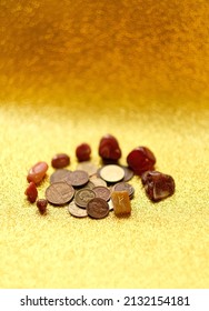 different old coins, stone rune Fehu and minerals on yellow shiny glittering blurred background close up. Magic for attracting money, wealth. witchcraft money esoteric ritual. selective focus