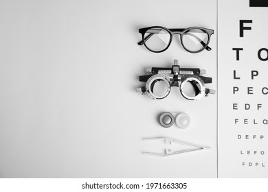 Different ophthalmologist tools on white background, flat lay