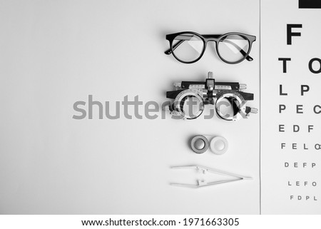 Different ophthalmologist tools on white background, flat lay