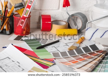 Different painter's tools on table. Decorating and design