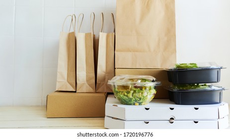 Different Paper Packages And Containers For Takeaway Food On Table. Takeout Meal, Delivery To Home, Food Delivery, Online Shopping Concept.
