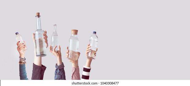 Different People Holding Water Bottles