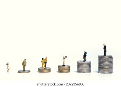 Different People On Stacks Of Coins Of Different Heights. Concept: Different Economic And Financial Status. White Background, Copy Space