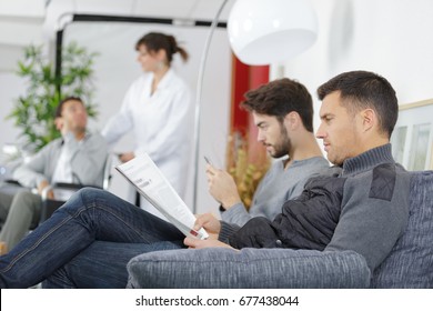 Different People Sitting In A Waiting Room Of A Hospital