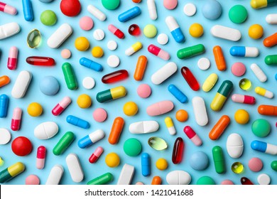 Different pills on color background, flat lay