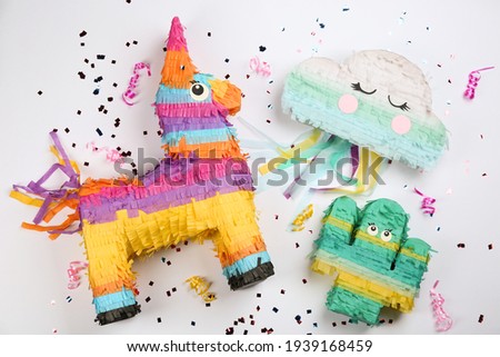 Different pinatas on white background, top view