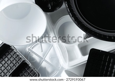 Different plastic containers on light background, closeup