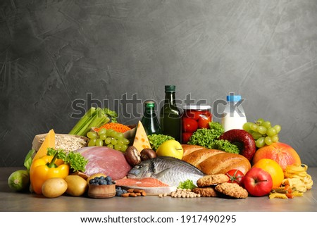 Different products on grey table. Healthy food and balanced diet