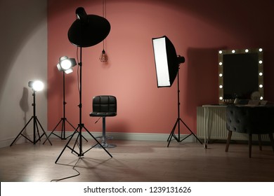 Different professional lighting equipment in modern photo studio