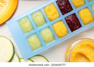 Different Purees In Ice Cube Tray And Ingredients On White Table, Flat Lay. Ready For Freezing