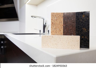 Different Quartz Kitchen Counter Top Samples On White Polished Countertop With Precise Processed Edges.