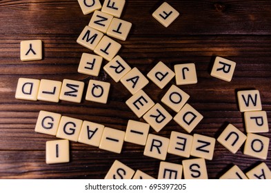 Different random letters on rustic wooden table
