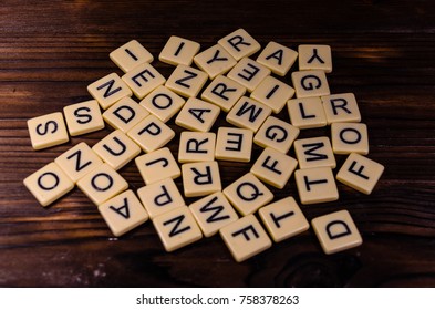 Different random letters on rustic wooden table