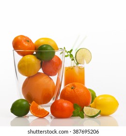 Different Refreshing Citrus Fruits And Fruit Cocktail Against White Background; Cocktail Ingredients; Vitamin Suppliers; Fitness Drink