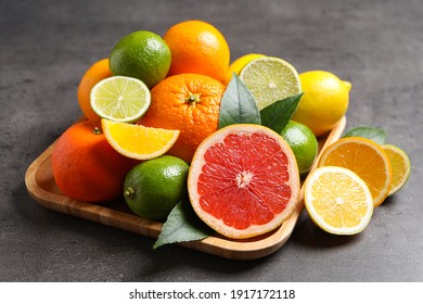 Different Ripe Citrus Fruits On Black Table