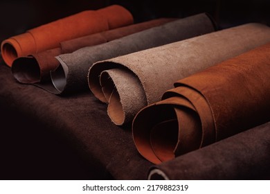 Different rolls of natural color leather on rack in workshop. Materials for DIY handmade craft. - Shutterstock ID 2179882319