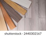 Different samples of wooden flooring on surface, top view. Space for text