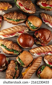 Different Sandwiches On A Wooden Table