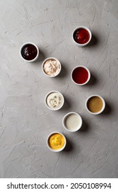 A Lot Of Different Sauces And Dips On Stone Grey Background, Fashionable Ad Photo