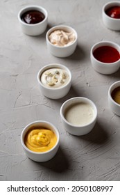 A Lot Of Different Sauces And Dips On Stone Grey Background, Fashionable Ad Photo