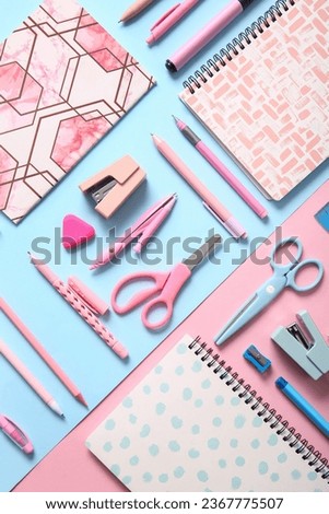 Different school stationery and notebooks on colorful background