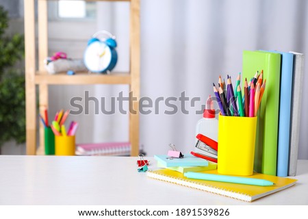 Different school stationery on white table indoors. Space for text