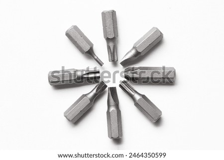 Different screwdriver bits on white background, top view