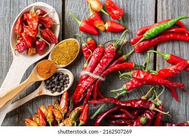 different seasonings for cooking, varieties of hot chilli pepper, ground pepper and spices, oil. for the text recipe	
				