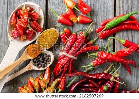 different seasonings for cooking, varieties of hot chilli pepper, ground pepper and spices, oil. for the text recipe	
