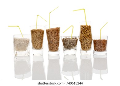 Different Seeds And Grains For Healthy Vegan Milk -  Rice, Soya, Oat, Hemp, Buckwheat And Wheat In Glasses Isolated On White Background.