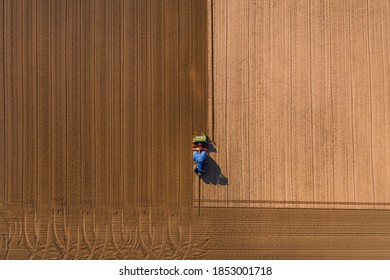 Different shades of brown appear on a field that is plowed with a tractor - Powered by Shutterstock