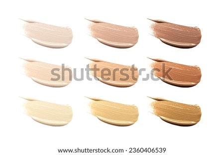 Different shades of liquid skin foundation on white background, top view. Set with samples of makeup product 商業照片 © 
