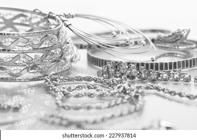 Different Silver Jewelry On The Table.