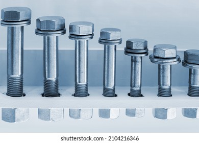 Different Size Bolts With Nuts Are Screwed As A Sample For Sale. Toned Image