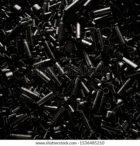 Different size bullet shells on the black ground. War concept. production of ammunition at the factory. brass bullet shell, ammunition manufacturing process