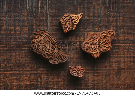 Different size of fish shape wood block pattern for textile printing on rustic wood background. Block Printing,Rajasthan India Block Printing, Wood block used for handmade textile printing,Hand craft
