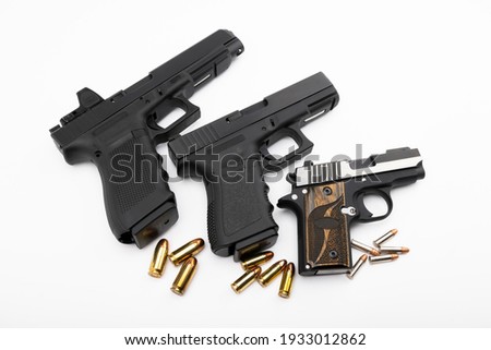 Different size of Semi automatic hand gun and bullets on white background , Comparison of guns