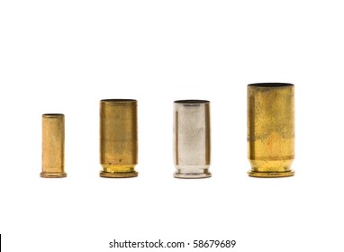 Different sized bullet casings over white background