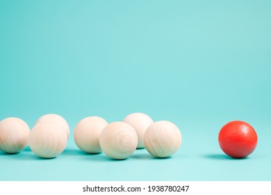Different small red ball in the group of wooden balls on green background, leader or influencer with follower, branding and marketing concept - Shutterstock ID 1938780247